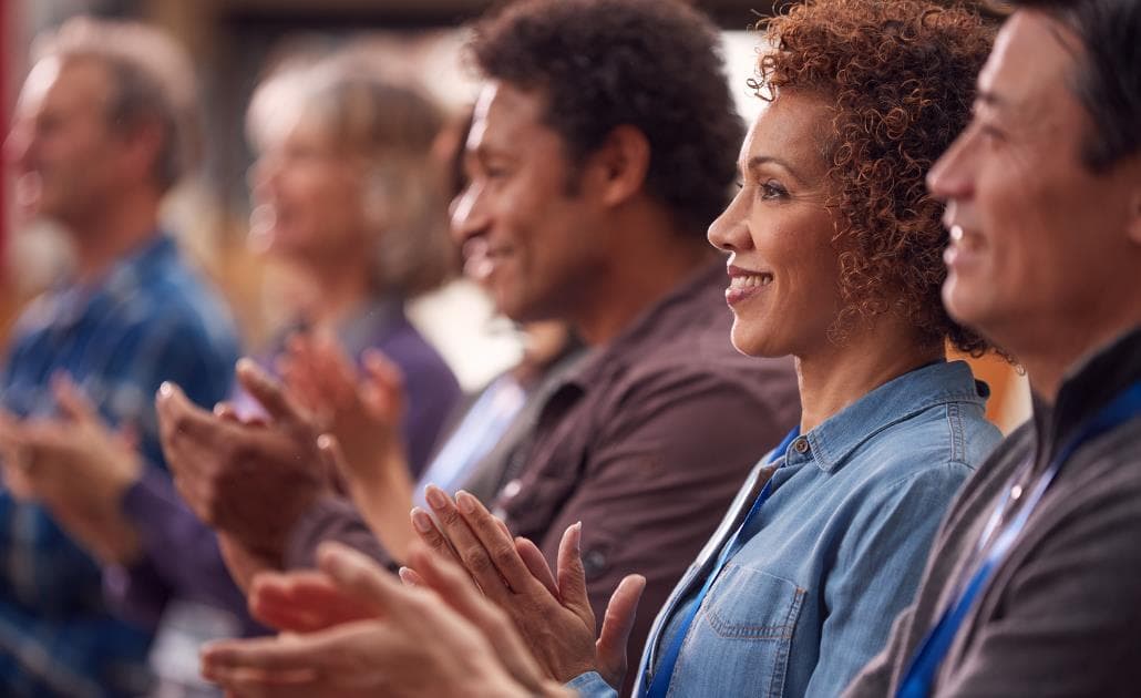 Business people clapping at conference 1030 x 630
